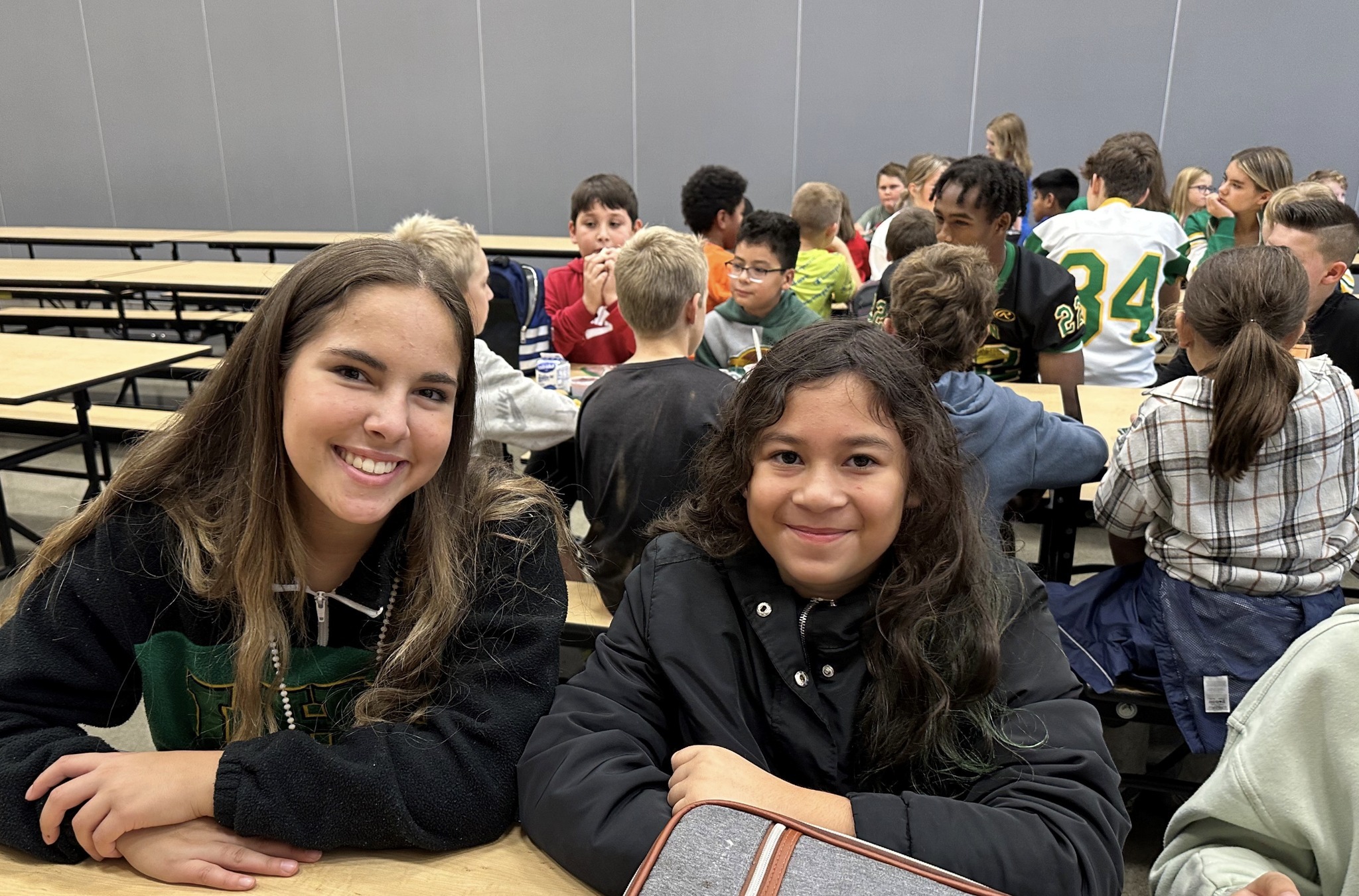 Two friends looking at the camera and smiling